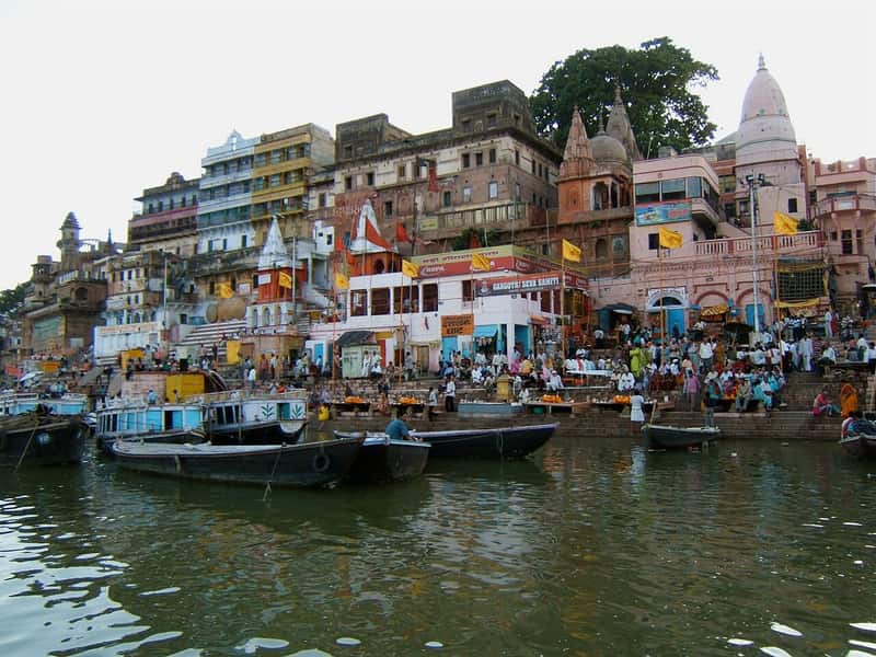 Morning bathers at the water's edge of Ahilyabai Ghat