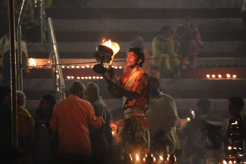 Earthen lamps and marigold petals on the steps during Kartik Purnima