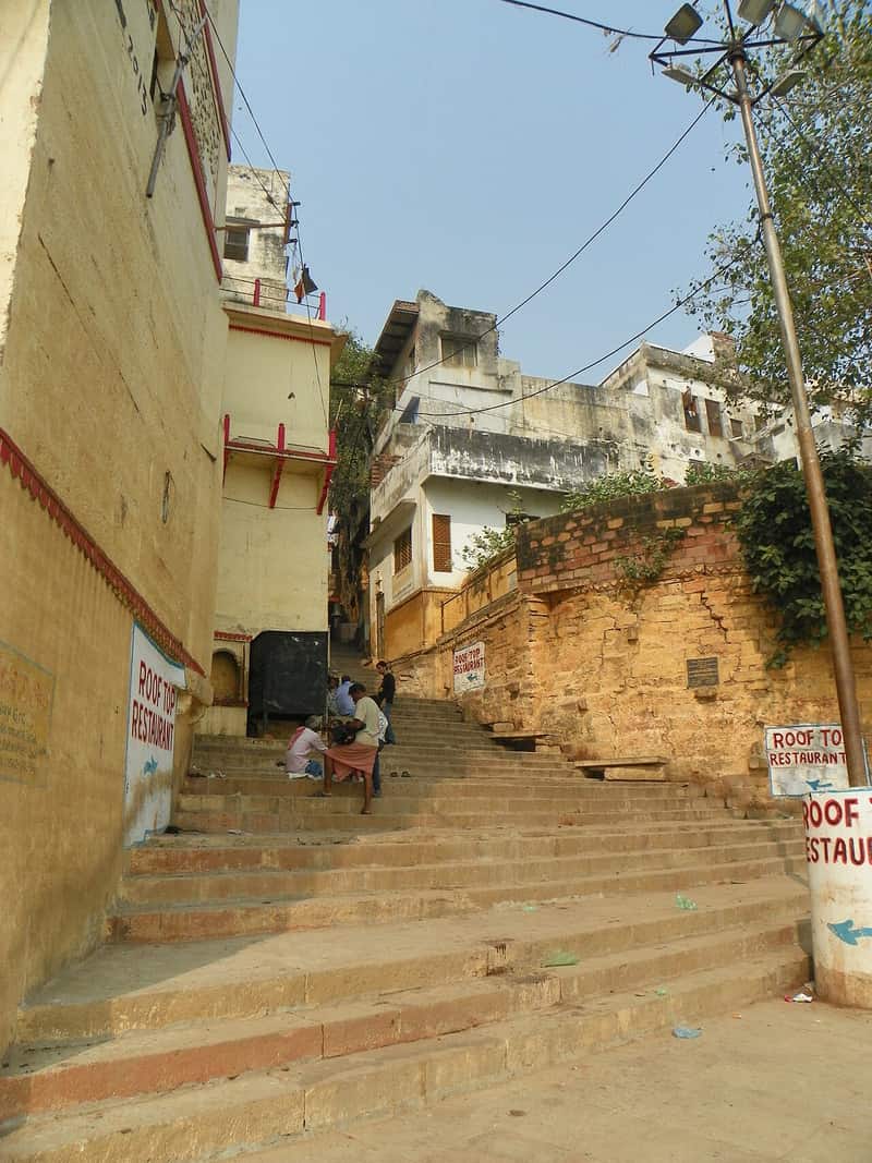 A boat approaching the steps of Brahma Ghat from the river