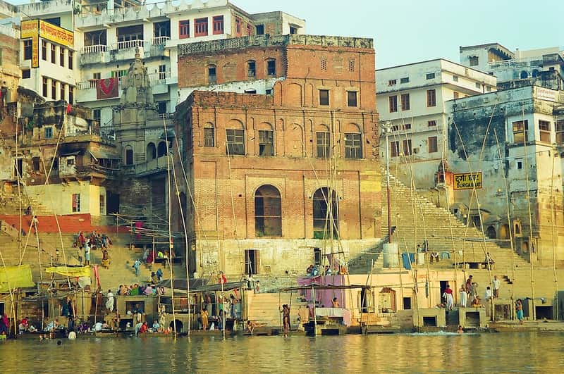 The shrine of Goddess Durga above the ghat steps with marigold garlands and incense