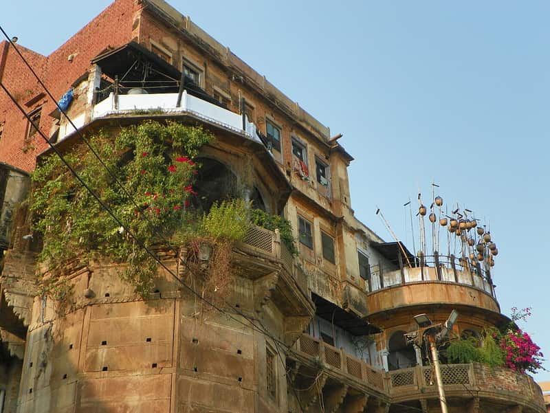 A priest seated at a shrine on Ganga Mahal Ghat