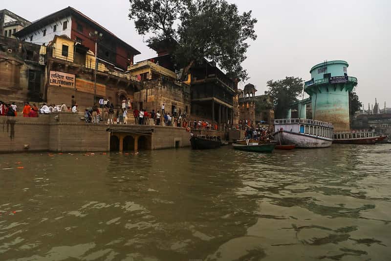 Pilgrims paying their respects at a small shrine on the ghat
