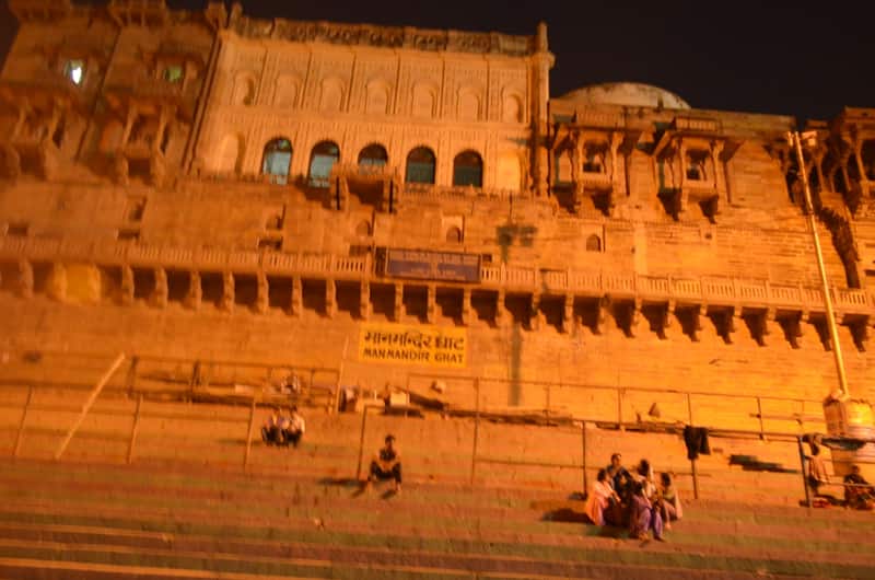The steps of Man Mandir Ghat with bathers and boats on the waterline
