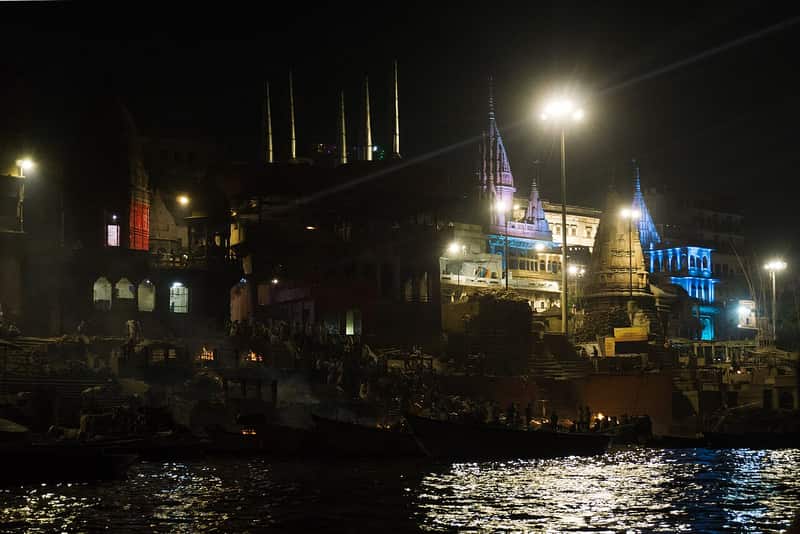 Manikarnika Ghat at night, the sacred flames glowing