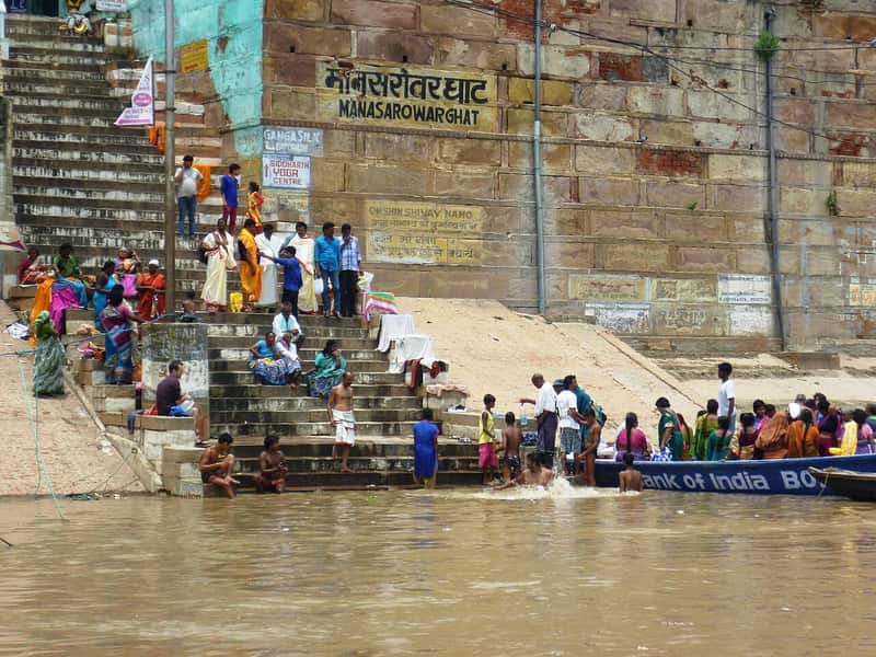 Detailed stonework and balconies of the buildings behind the ghat