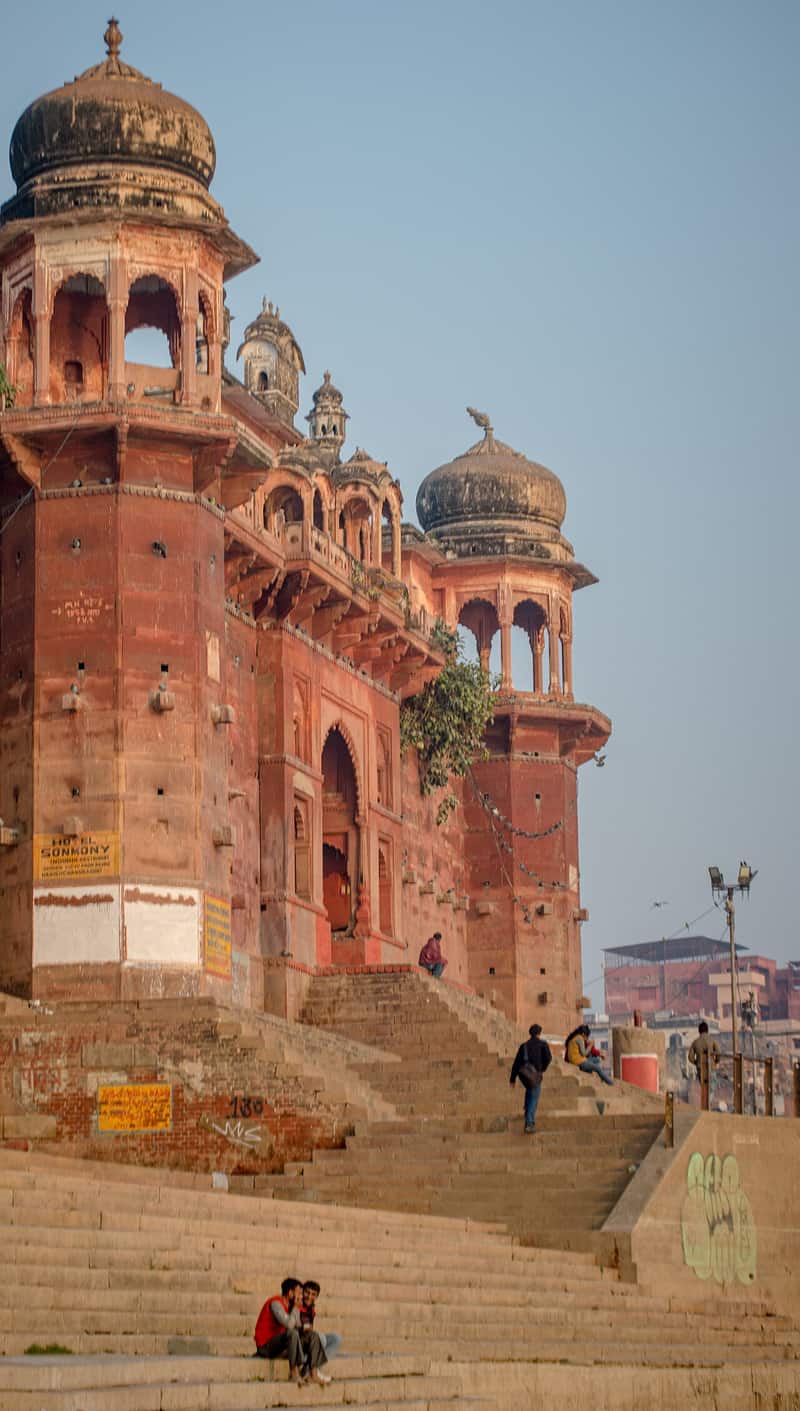 The southern ghats at golden hour with boats on the Ganga