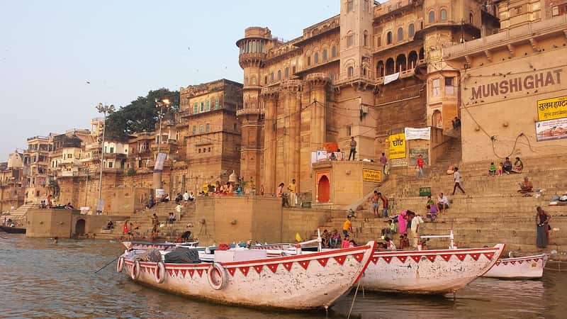 Painted palace facade of Munshi Ghat with broad steps descending to the Ganga
