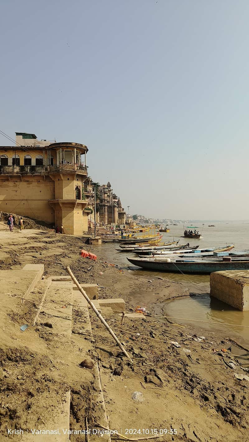 Photographers framing the painted facade of Munshi Ghat in the morning light