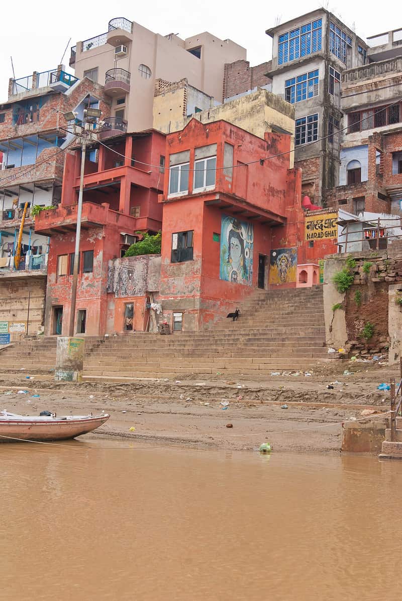 Old nameplate and small shrine near the ghat steps