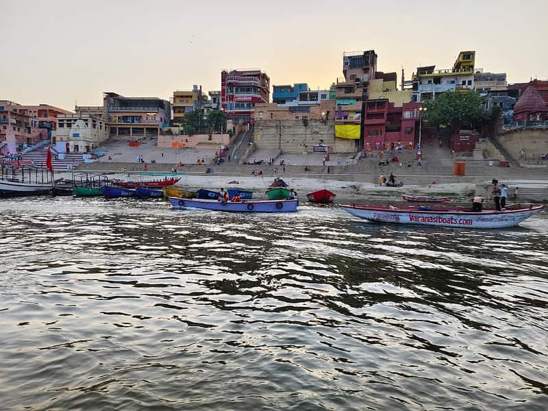 Devotional singers with harmonium and tabla on the ghat steps