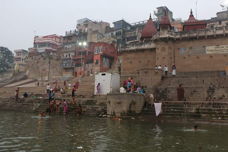 Boatmen mooring wooden boats at the ghat