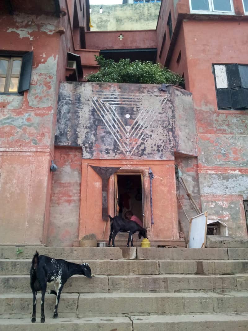 A priest performing puja at the water's edge