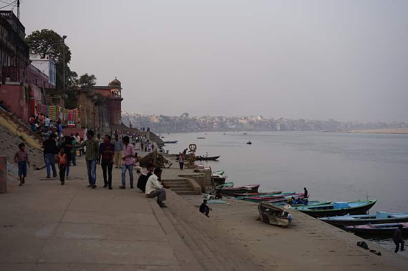 Moored wooden boats along the shore at Prabhu Ghat