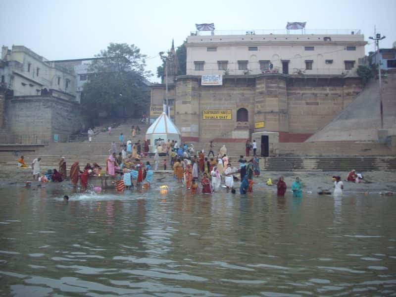 Pilgrims performing ritual ablutions at the water's edge of Shivala Ghat