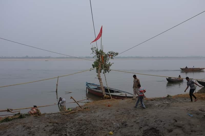 Quiet lanes behind Tulsi Ghat with Hanuman imagery