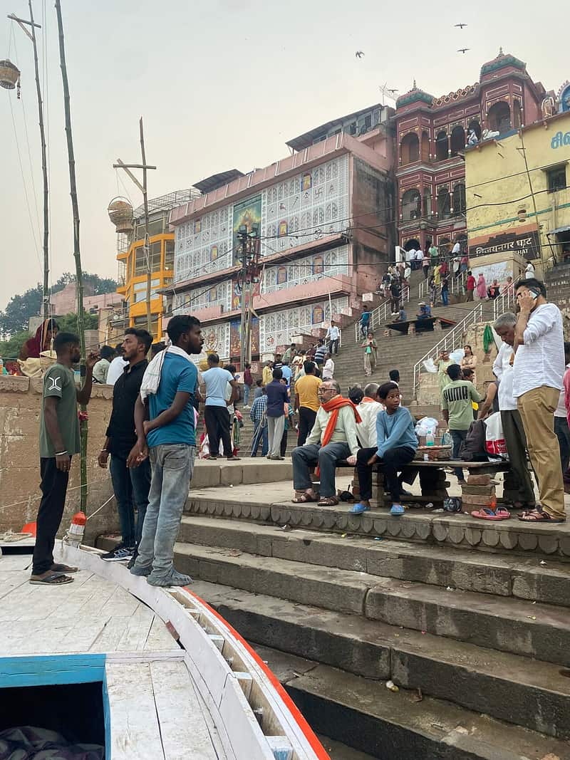 A priest offering blessings to pilgrims on the ghat platforms